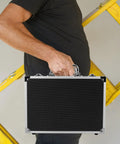 Lockable Aluminum Alloy Toolbox With Ergonomic Handle Rock Solid Portable Storage Case For Mechanics And Builders Multi Purpose Workgear lightweight chest held by a person with yellow ladder in the background.