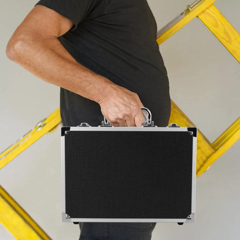 Lockable Aluminum Alloy Toolbox With Ergonomic Handle Rock Solid Portable Storage Case For Mechanics And Builders Multi Purpose Workgear lightweight chest held by a person with yellow ladder in the background.