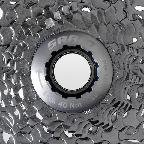 Close-up of PG-1070 10 Speed Cassette 11-28T with silver finish, highlighting durable steel cogs and lightweight aluminum spider for smooth shifts.