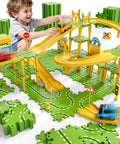 Child playing with Epic 4 Tier Puzzle Race Car Track Set for Kids Ages 3 to 8 with 51 pieces bridges overpasses road signs cars.