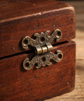 Close-up of a Vintage H Shape Zinc Alloy Hinge on a small wooden box, showcasing ornate filigree edges for antique furniture projects.