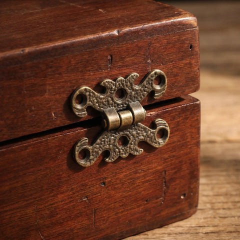 Close-up of a Vintage H Shape Zinc Alloy Hinge on a small wooden box, showcasing ornate filigree edges for antique furniture projects.