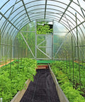 Greenhouse interior featuring Heavy Duty Weed Barrier Landscape Fabric 3 Ft Wide By 300 Ft Long Ground Cover Mat on soil pathways.
