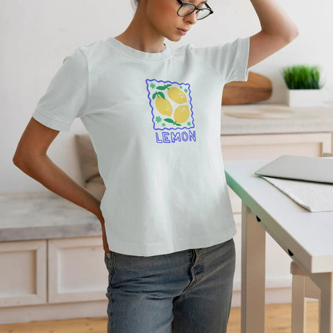 Person wearing a t-shirt with lemon design, created using Lightweight Inkjet Printable Heat Transfer Paper For Light Fabrics Iron On HTV Sheets 8x11 Inches 25 Sheets Made In USA Perfect For T Shirts Hoodies Bags And Hats.