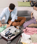 Two people packing suitcases; the image includes a setup using a 120 Pack 6 Inch Reusable Cable Ties Set For Home And Office Use.