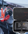 Rugged Hard Case For NOCO Boost Plus Air AX65 2000A Jump Starter With Air Compressor And Tire Inflator Protective Black Carry Case With Easy Zip Access open next to car battery with jumper cables