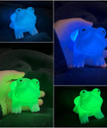 Ultra Cute Frog LED Night Light For Kids Room With Automatic Color Changing LEDs glowing blue and green in dark setting