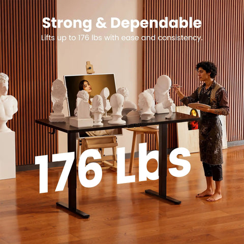 Electric Height Adjustable Sit Stand Desk 48 By 24 Inches With Memory Presets carrying sculptures in an art studio