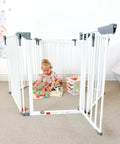 Toddler playing inside Royale Converta 3 In 1 Play Yard And 151 Inch Wide Baby Gate, 6 configurable panels with toys.