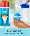 Next Level Electric Shaved Ice And Snow Cone Maker pouring blue syrup over a fluffy snow cone in a cup on a countertop.