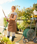 Woman watering garden with Mobile Hose Reel Cart With Wheels Holds Up To 200 Feet Of Five Eighth Inch Hose Heavy Duty Steel Frame