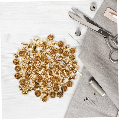 Versatile Craft Kit 100 Pcs Round Mushroom Brads And Mini Paper Fasteners in a pile on a white wooden surface