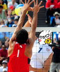 Men playing volleyball at a competitive match with a colorful ball on an outdoor court.
