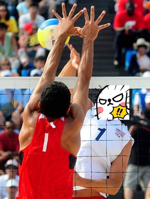 Men playing volleyball at a competitive match with a colorful ball on an outdoor court.