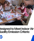 Family drawing and crafting together at a coffee table while enjoying HP's air quality emissions compliant products.