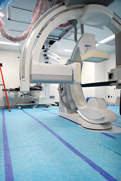 Aqua Shield Surface Protector 10 Mil 36 Inch By 100 Foot Heavy Duty Protective Film in use on surgical room floor under medical equipment