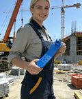 Person holding blue Anchor Bolt Holder Five Eighths Inch Handle Saver, Reusable Clamp For Precise Concrete Bolt Installation at construction site.