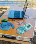 Insulated Water Bladder Tube Cover Keeps Hydration Cold Or Hot Must Have For Hiking And Camping, blue rubber sleeve on table.