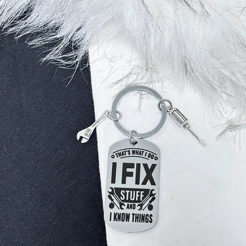 Thats What I Do I Fix Stuff And I Know Things Mechanic Keychain Gift in silver with wrench and screwdriver charms on soft surface
