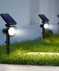Solar Powered Outdoor Landscape Spotlight Set Of 4 Waterproof Security Lights With Adjustable Angles installed on grass