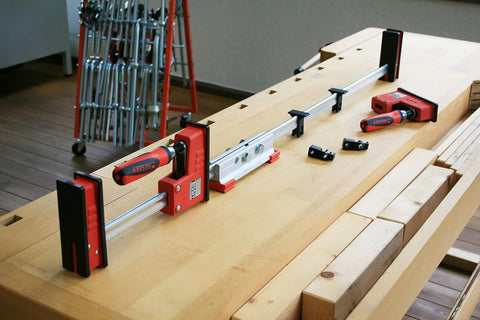 K Body REVO Extender for Dual Clamp Sets Connects Two KRE KR K KREV or KRV Clamps on wooden workbench