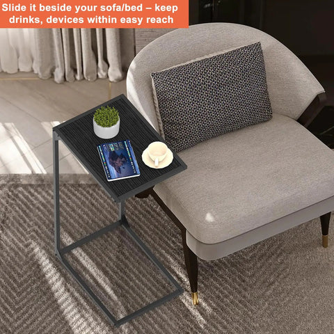 Set Of 2 C Shaped End Tables That Slide Under The Sofa For Easy Laptop Work Or Snack And Drink Tray And TV Tray Space Saving Black Living Room And Bedroom Couch Side Tables with plant, book, and mug