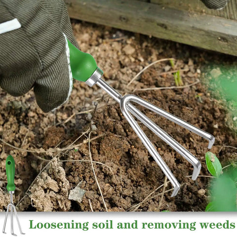 Hand using Three Tine Claw Garden Rake With Ergonomic Handle And Stainless Steel Build for loosening soil and weeding in garden