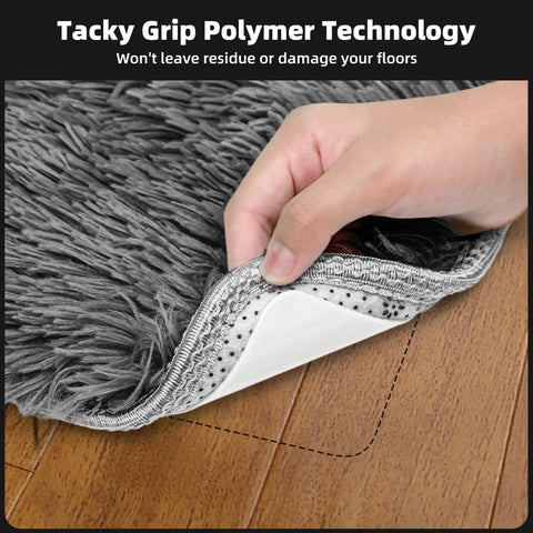 Hand lifting rug corner showing 8 Pack Non Slip Rug Grippers For Hardwood Floors Washable And Reusable Carpet Tape on wood floor