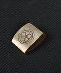 Dope Brass Habaki Collar Clip For Katana And Japanese Swords with engraved floral design, shown on textured surface