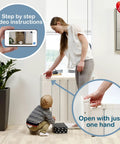Mother using Guard Me Retractable Safety Gate for Extra Wide Openings 21.6 to 44.6 Inches; fits stairs and hallways; 28.5 inch height