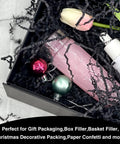One Pound Crinkle Cut Paper Shred Filler For Gift Boxes Baskets And Bags Perfect For Holidays Parties Sub Boxes And Mailers Eco Friendly Recyclable Black Shredded Paper Packaging Filler with pink bottle and ornaments in box