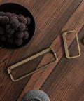 Champagne Bronze Cabinet Pulls Six Pack Modern Zinc Alloy Finger Drawer Pulls shown on a wooden table with fruit bowl