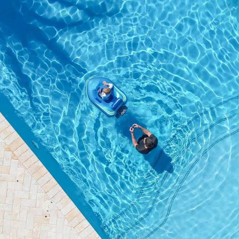 Remote Control Baby Pool Float With Enclosed Propeller Guard in water with child and adult controlling with remote