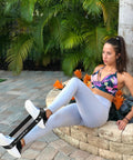 Woman using Heavy Duty Resistance Loop Bands Set Of 5 With Travel Pouch And Instruction Guide for leg exercises