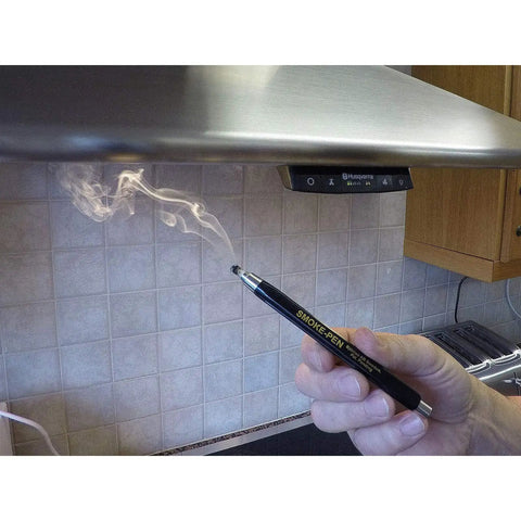 Using Smoke Pen Kit With 3 Smoke Sticks for airflow testing under range hood, demonstrating precise leak detection.