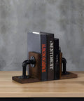 Legit Industrial Bookends Featuring Charred Pine And Genuine Metal Pipe Fittings And Badass 2 Piece Set For Modern Farmhouse Desks and Rustic Steampunk Home Decor, dark wood and pipe setup holding books.