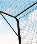 Corner of Portable Mobile Baseball Batting Cage With Wheels 36ft Net With Padding Easy Setup On Any Surface against blue sky