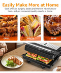 Aigostar Silver 1000W Panini Press Grill With Ceramic Nonstick Plates For Even Cooking Bacon Burgers Chicken Steaks And Reheating Personal Pizza, compact grill in use with pressed sandwich and grilled salmon.