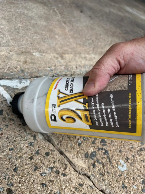 Hand applying 2X Concrete Crack Sealant Easy To Use No Mess Ready Mixed Filler For Cracks Up To Half Inch Self Leveling Gray