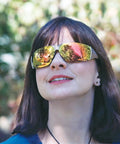 Pro Grade Sick Impact Resistant Outdoor Safety Specs With Rich Orange Mirrored Lenses And Ultra Tight Flex Comfort Fit Frame Built Different for non-stop heavy duty hustle worn by a woman outdoors.