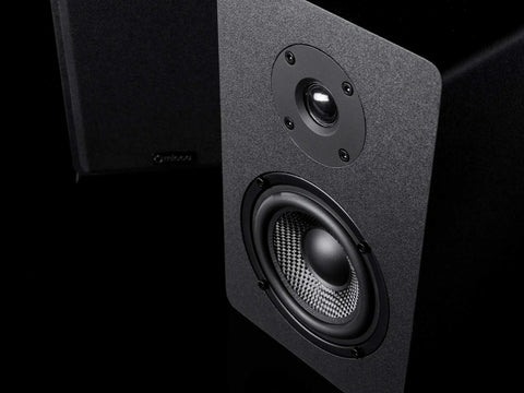 Close-up of PB42X Powered Bookshelf Speakers With 30 Watt RMS, showing carbon fiber woofer and silk dome tweeter, black finish.