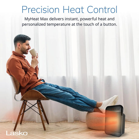 Cozy Up With MyHeat Max Portable Ceramic Space Heater For Indoor Use next to a seated man in a modern home setting