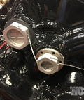 Close-up of machinery secured with 10.5 Inch Safety Wire Pliers With One Pull Action Wire Twister And Stainless Steel Cutter