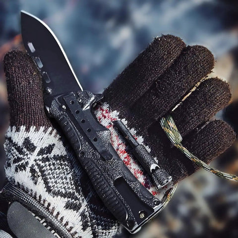 Gloved hand holding 3.74 Inch Sharp Blade Folding Knife With Fire Starter Whistle Paracord Handle Liner Lock EDC Survival Tool