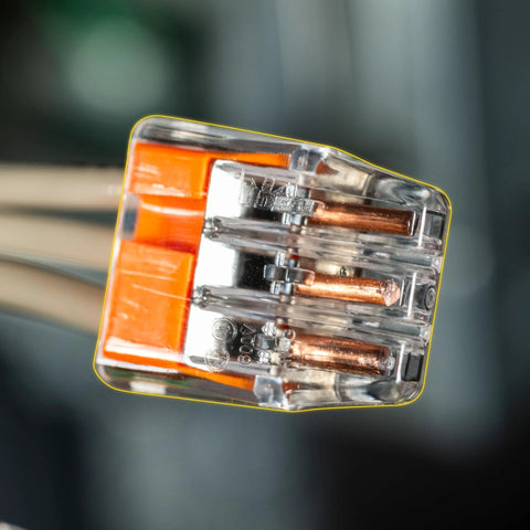 3-port Ideal In-Sure push-in wire connector, orange housing; copper conductors visible.
