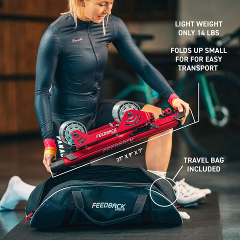 Woman packing Omnium Over-Drive Lightweight Portable Bike Trainer with Travel Bag, Adjustable Wheelbase and Fork Mount, Red.