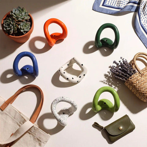 Set of Six Playful Ceramic Wall Hooks for Coats and Keys Game Changer Storage Solution Sweet Decorative Hangers Assorted Colors on table