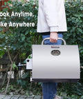 Person carrying Stainless Steel Portable Tabletop Gas Grill With 10000 BTU Power, 285 Square Inches Of Cooking Space, Folding Legs