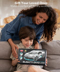 Mother and son holding Bugatti Divo 1 To 12 Scale Remote Control Car Licensed Two Point Four Gigahertz RC Model box on couch