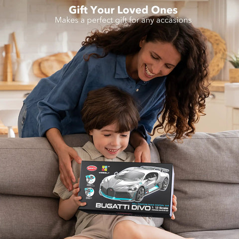 Mother and son holding Bugatti Divo 1 To 12 Scale Remote Control Car Licensed Two Point Four Gigahertz RC Model box on couch